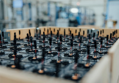 A wooden crate full of batteries. 