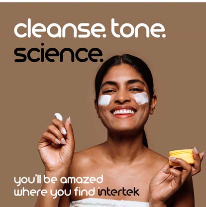 A woman smiling with facial cream on her cheeks